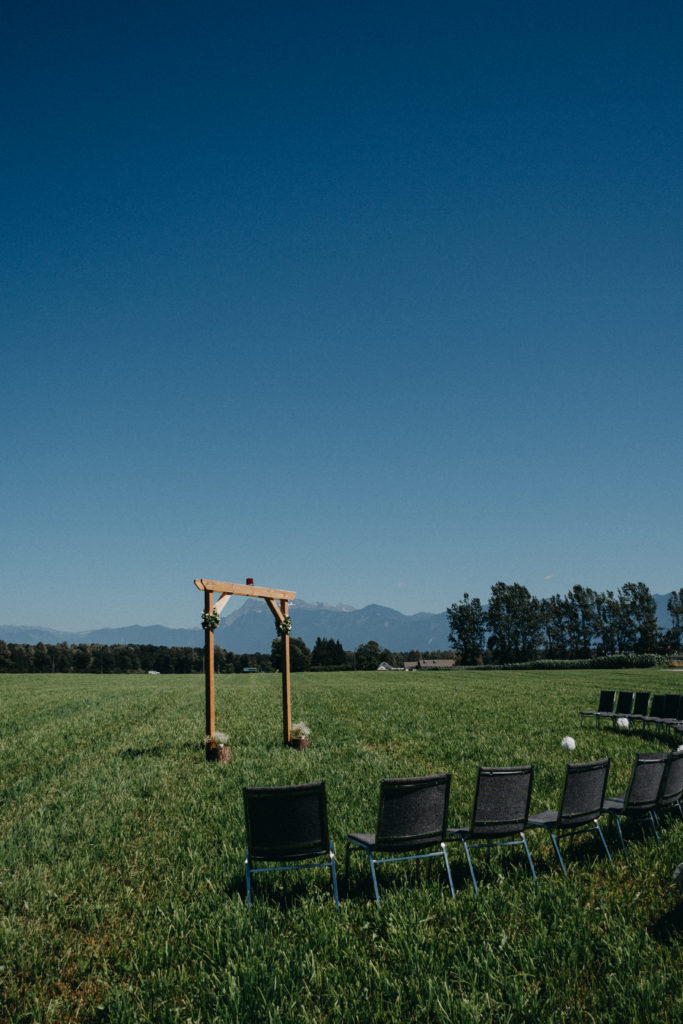 Ceremony location in a field surrounded by mountains