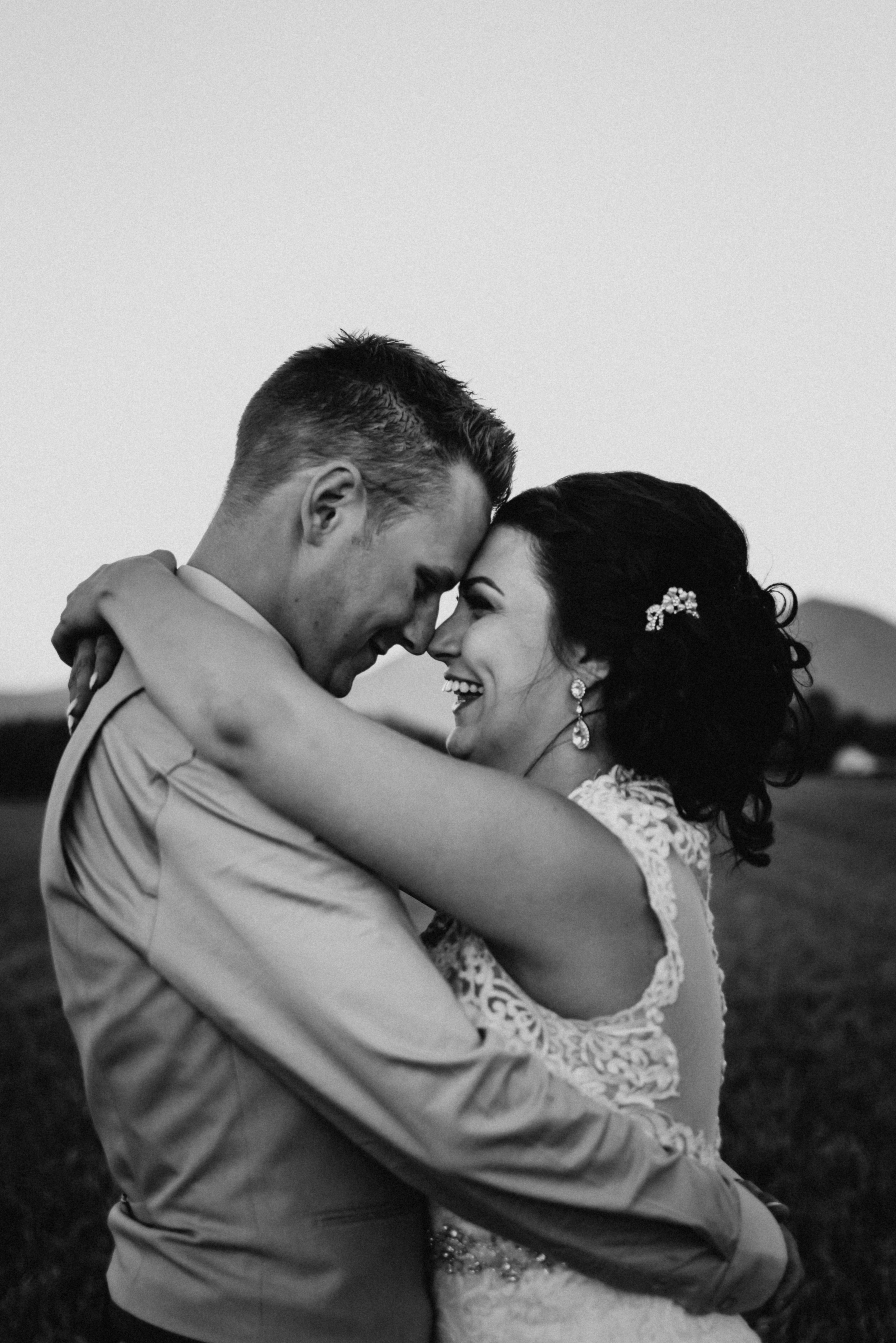 Bride and groom staring into each others eyes, black and white image