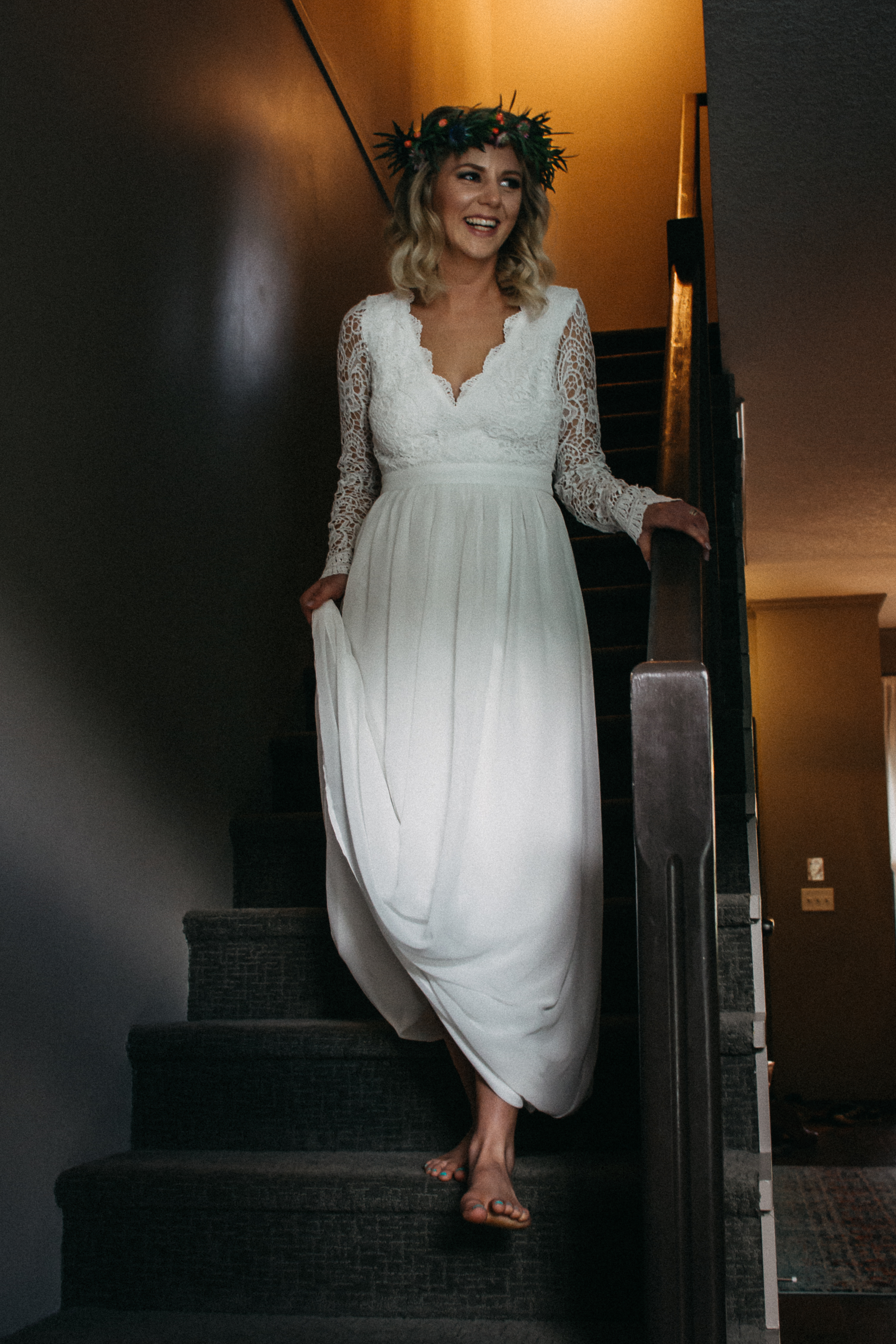 Bride walking down stairs in wedding dress