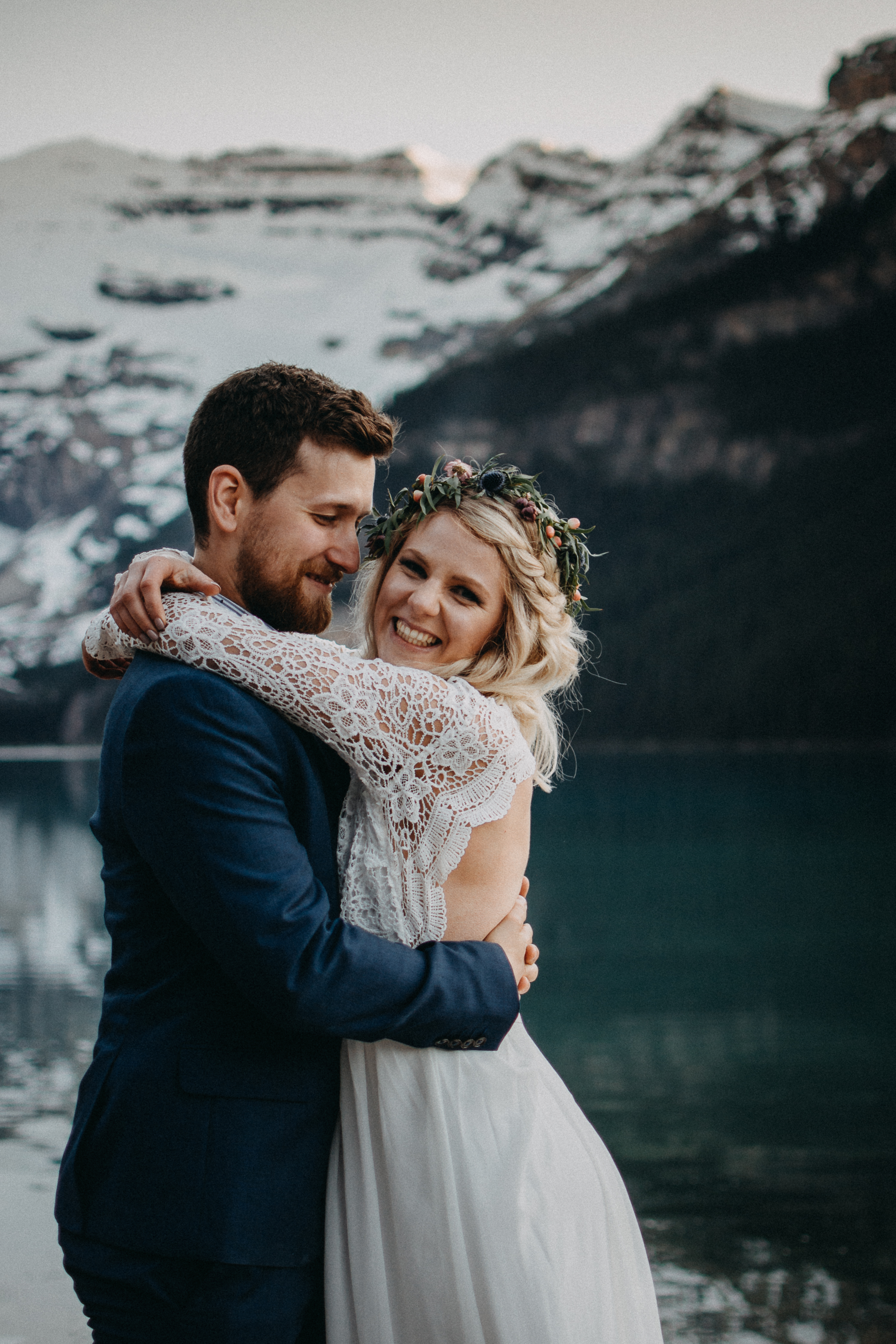Bride and groom laughing at Lake Louise, Alberta