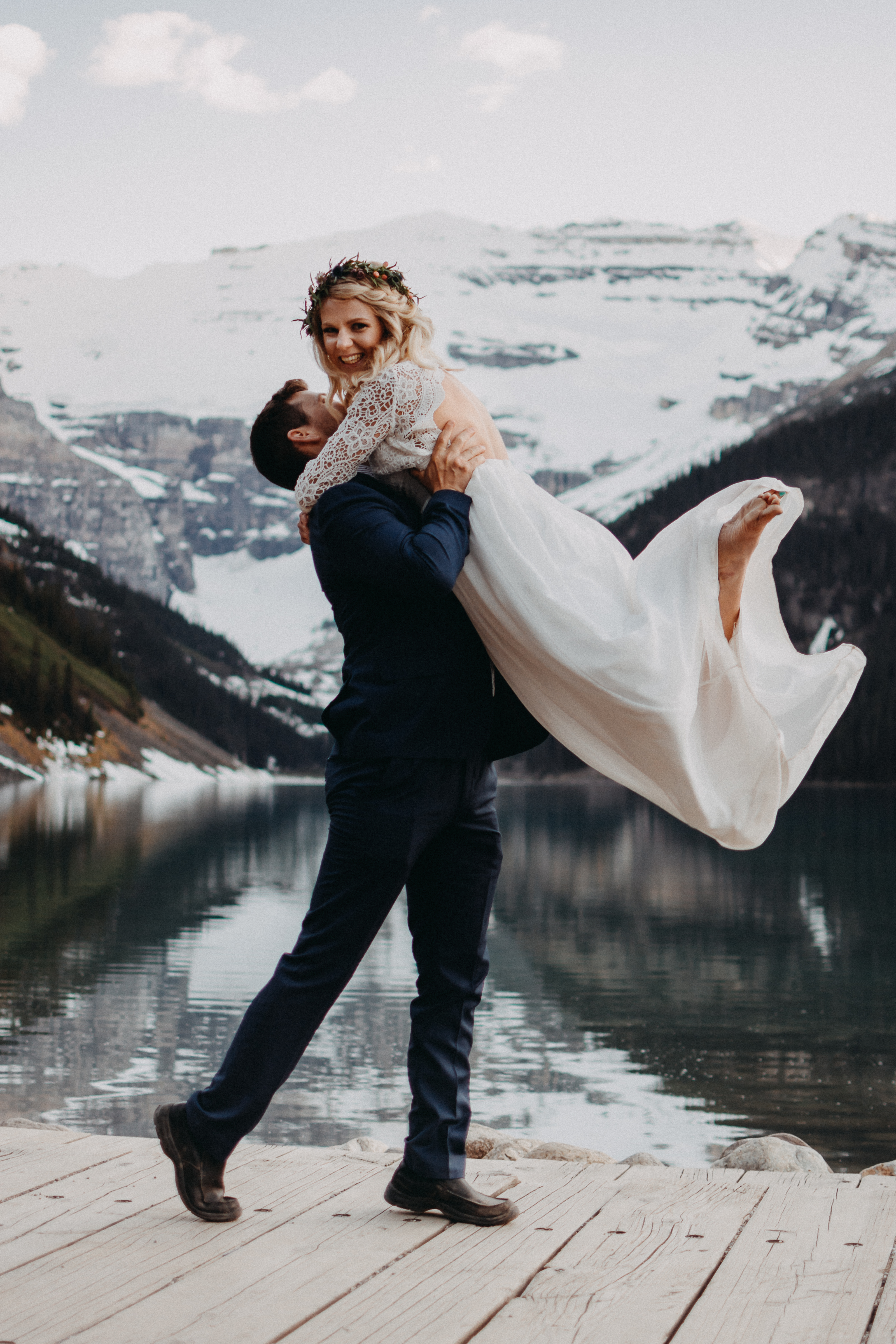 The groom lifting the bride up at Lake Louise, Alberta