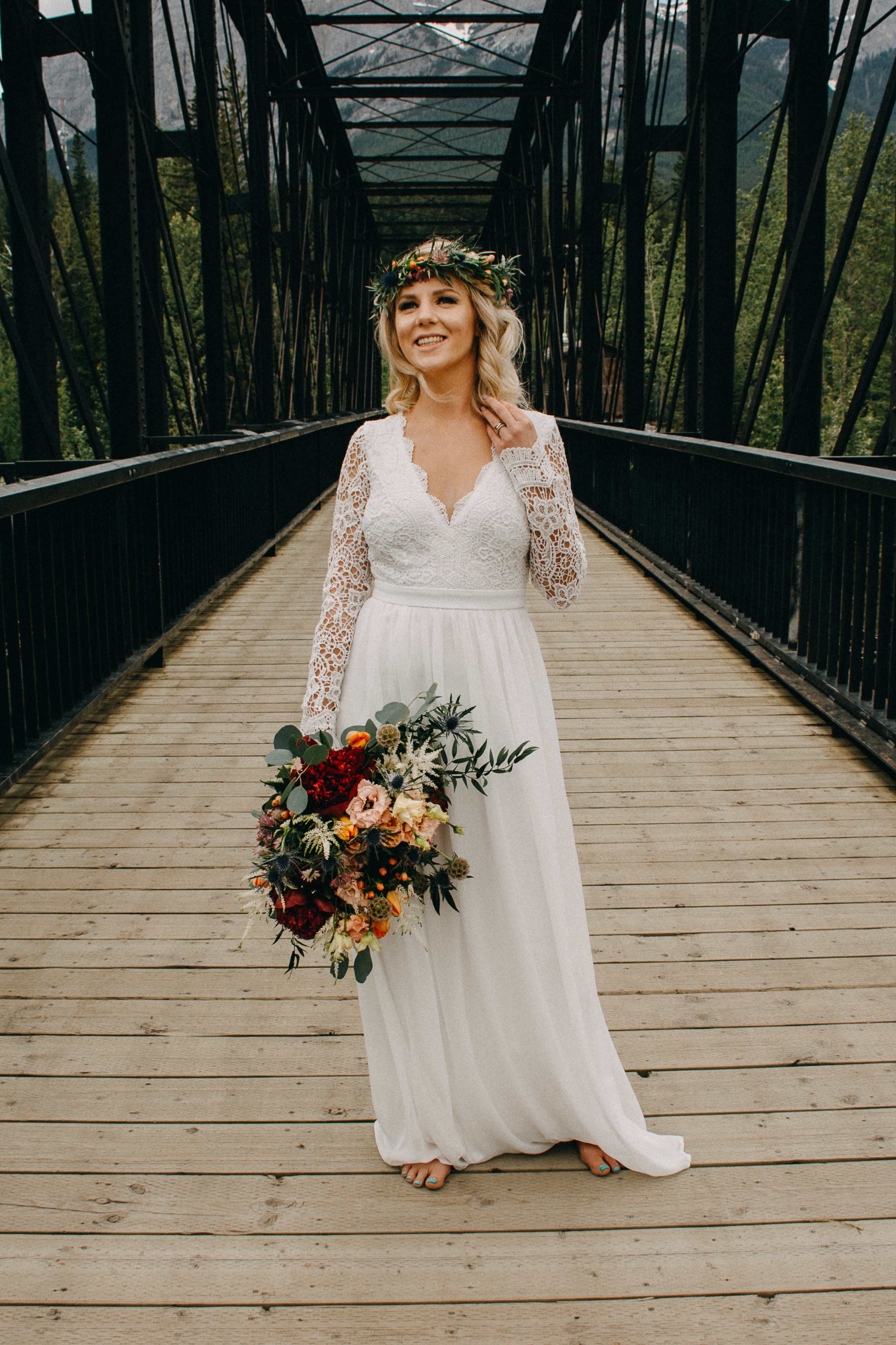 The bride holding her bouquet on the engine bridge in Canmore, Alberta