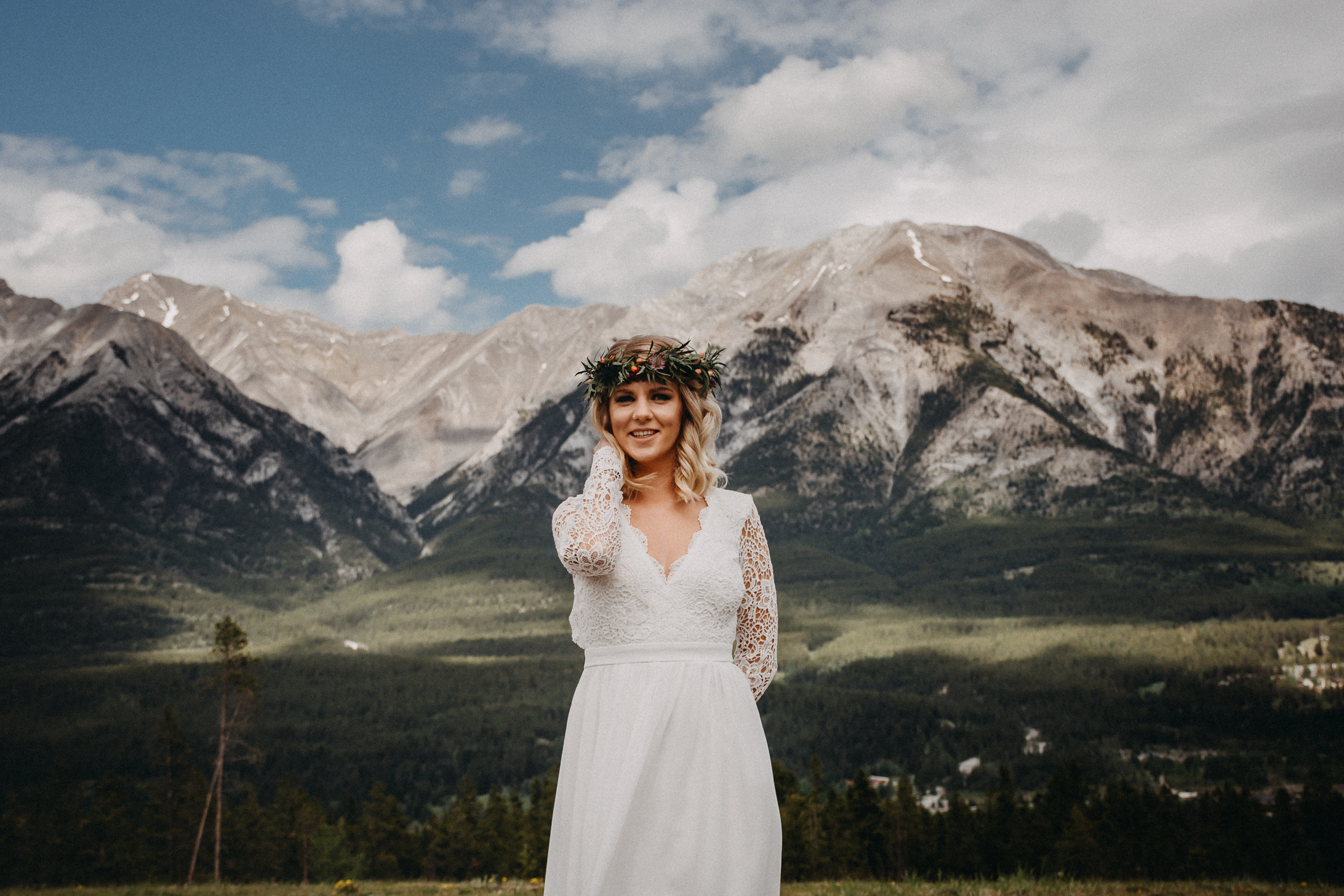 The bride posing in front of the rocky mountains