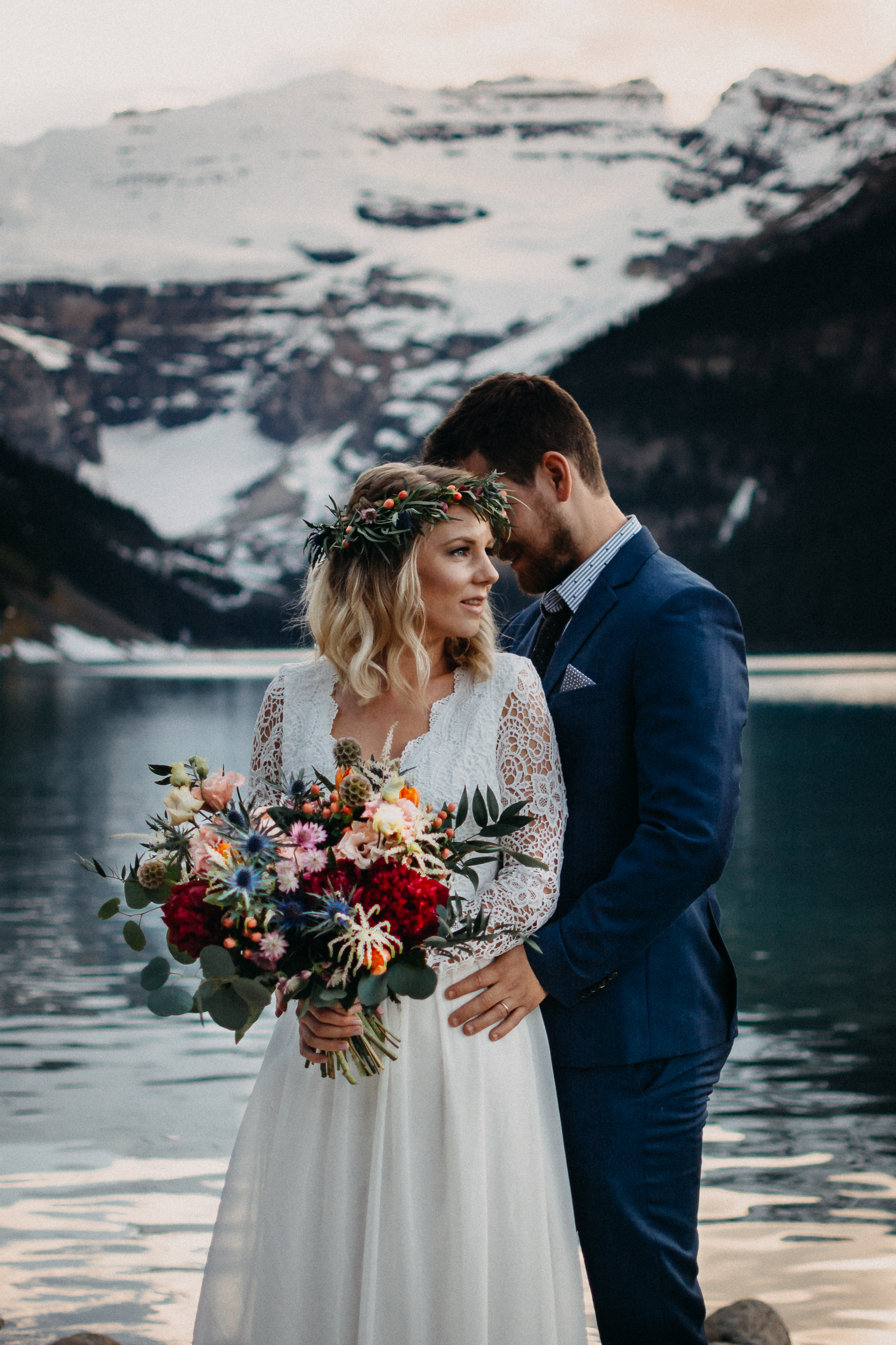 The bride and groom holding each other at Lake Louise, Alberta