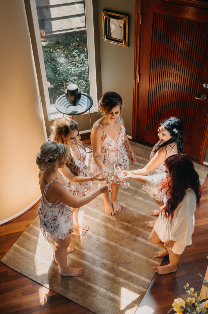 overhead shot of bridesmaids toasting with champagne