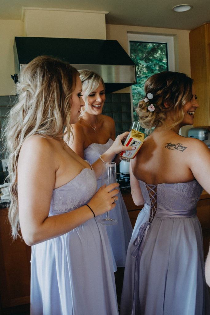 bridesmaids putting a package of butter against skin to cool down