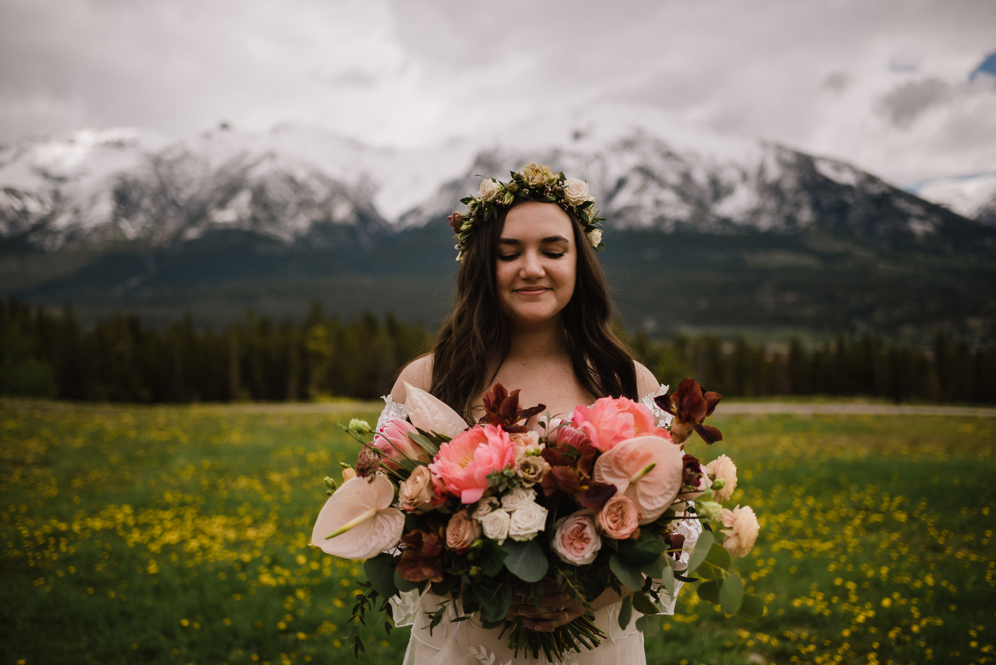 Bride holding beautiful bouquet at the Nordic Center, Canmore