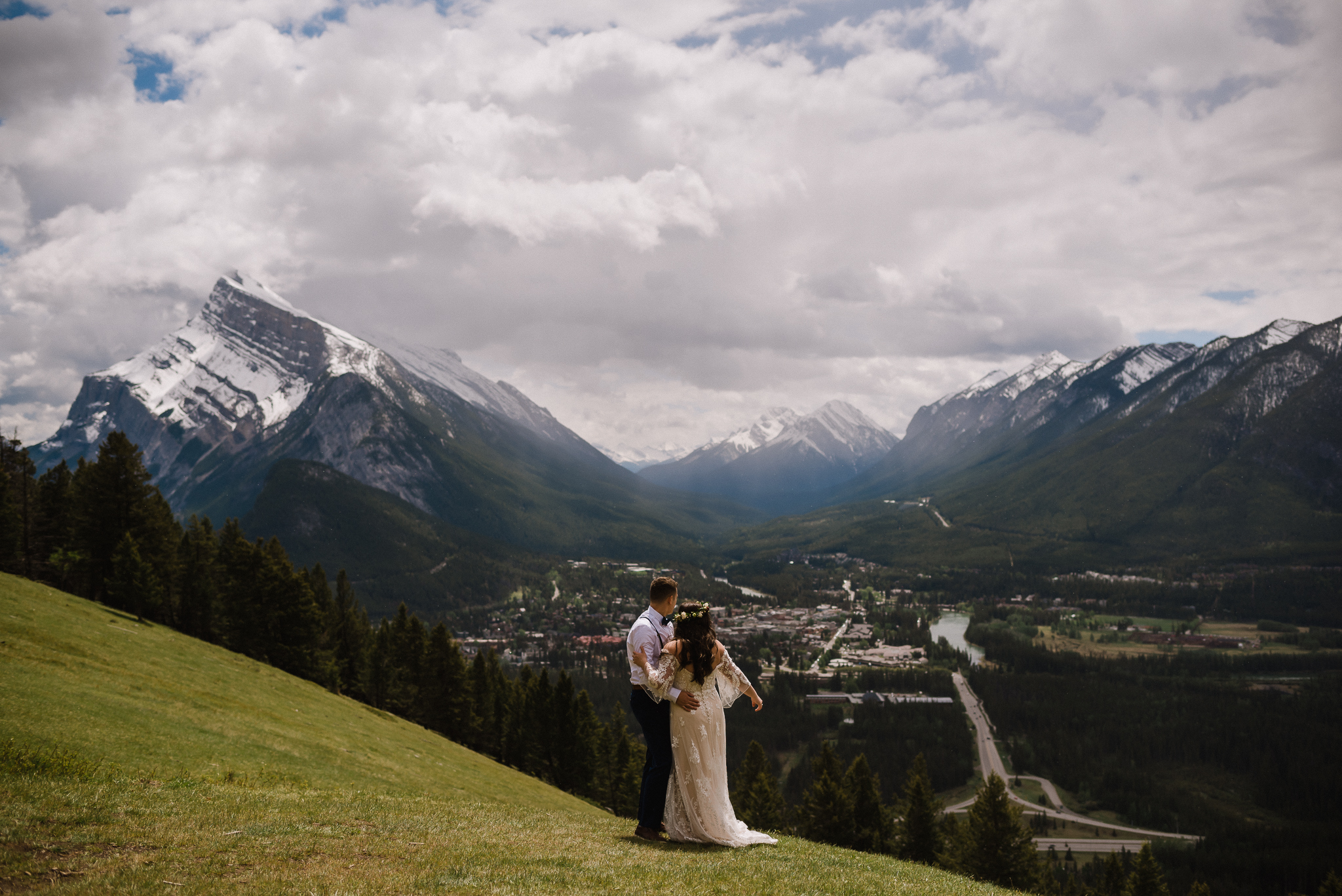 Bride and groom standing at Mount Norquay Lookout, Banff