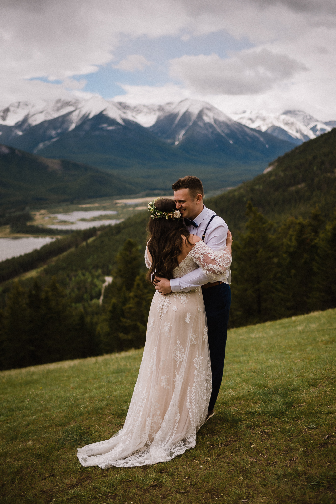 Bride and groom holding each other at Mount Norquay Lookout, Banff