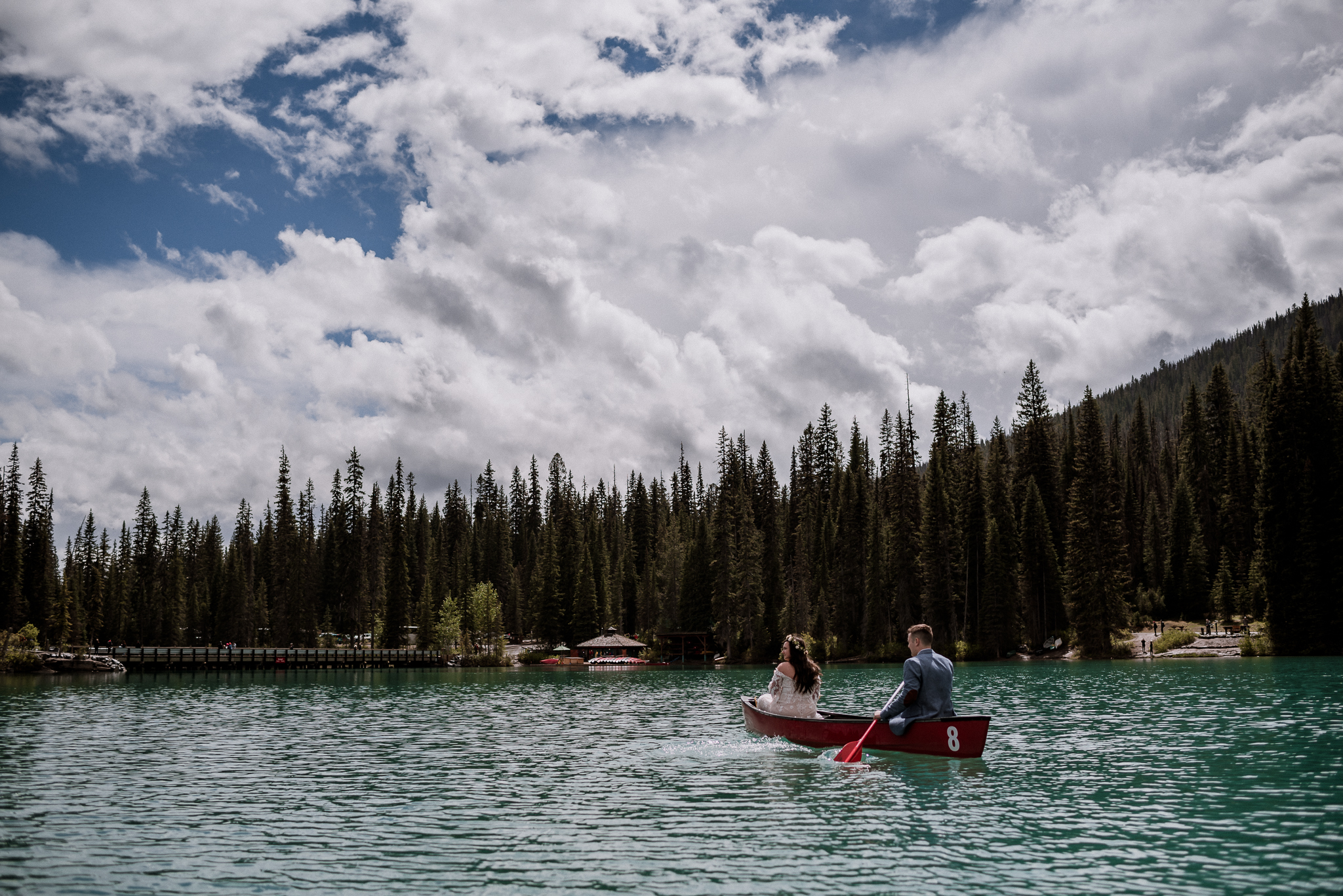 Bride and groom canoeing in the sun at Emerald Lake, BC