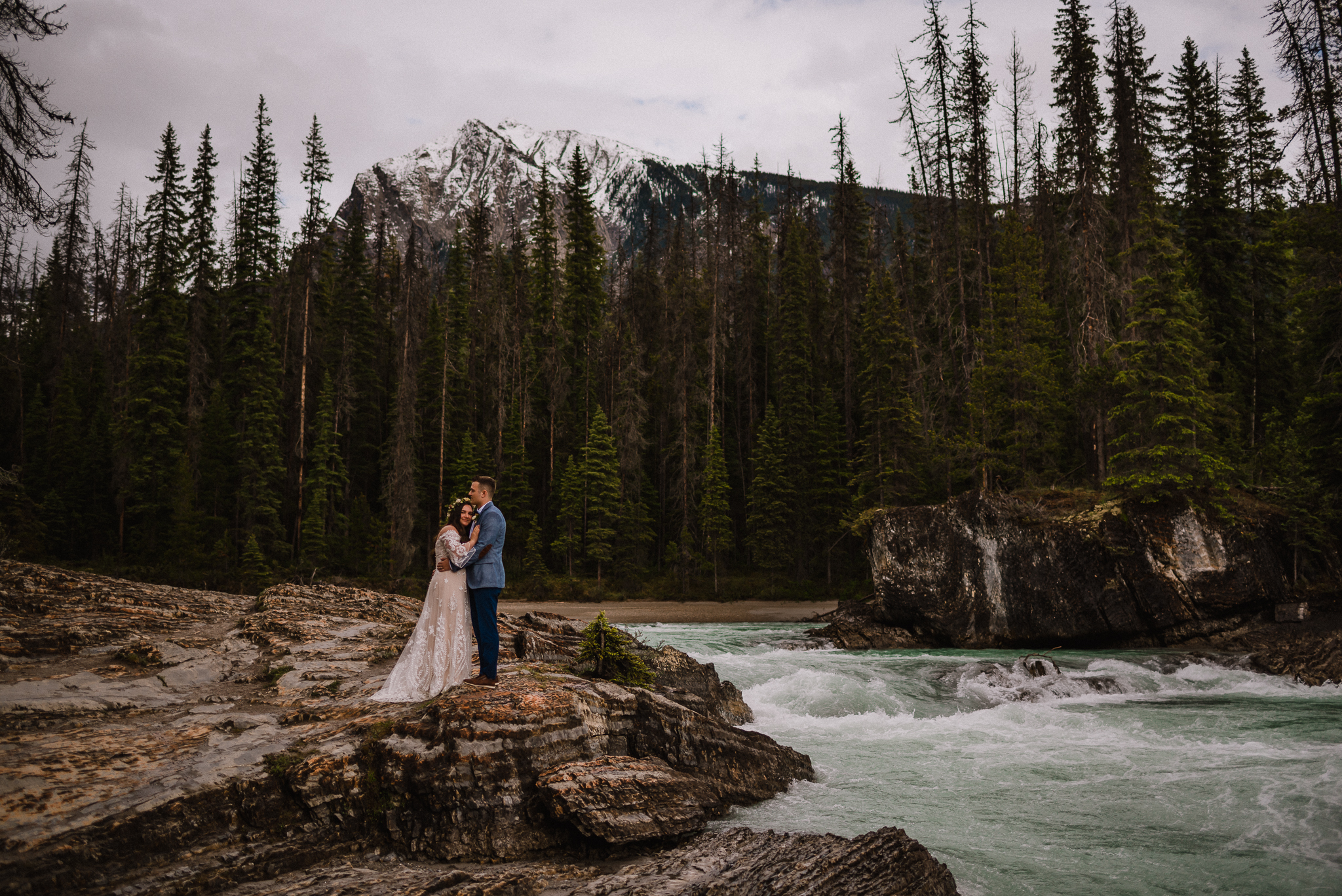 Bride putting her head on grooms chest at Yoho National Park