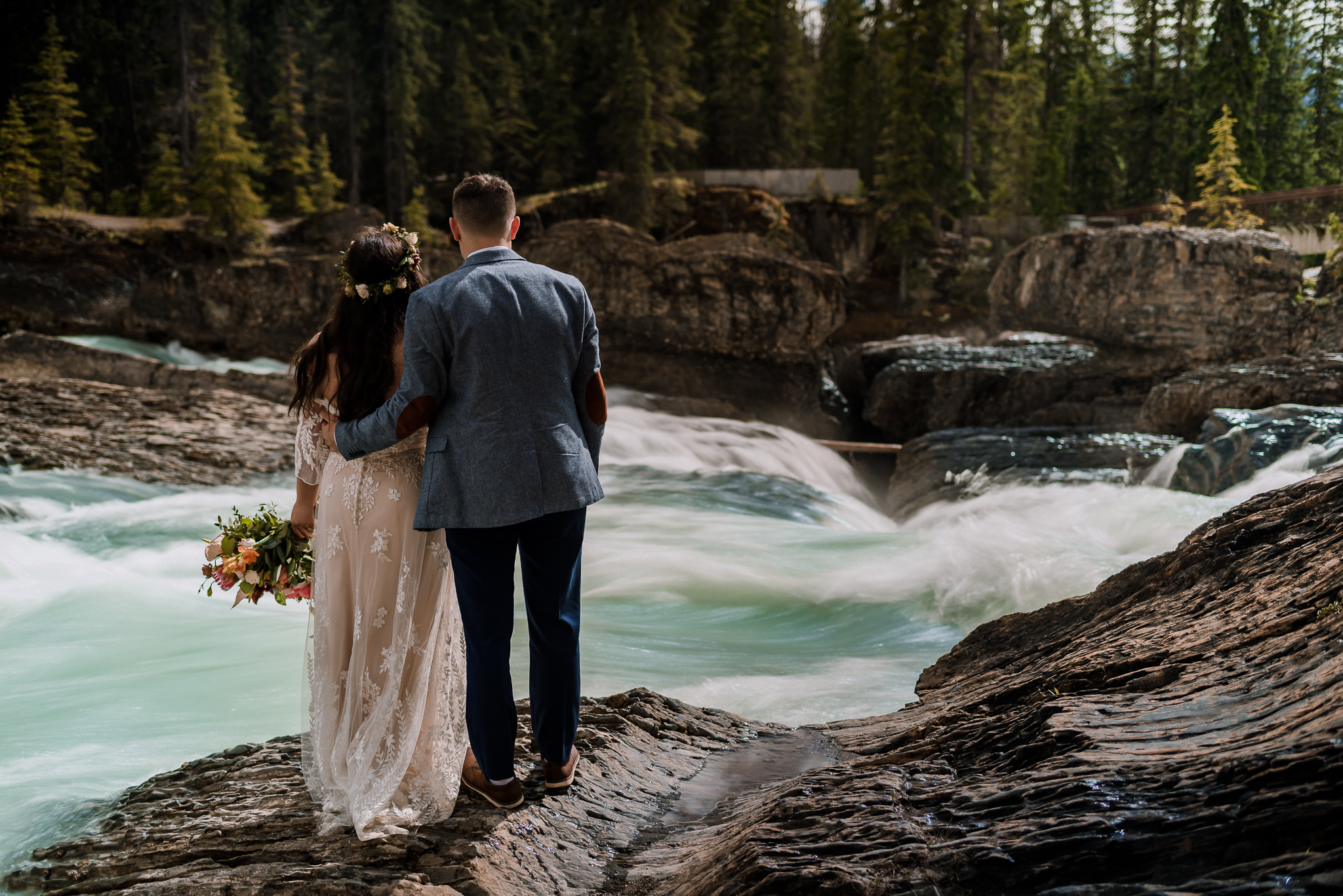 Bride and groom in front of river at Yoho National Park