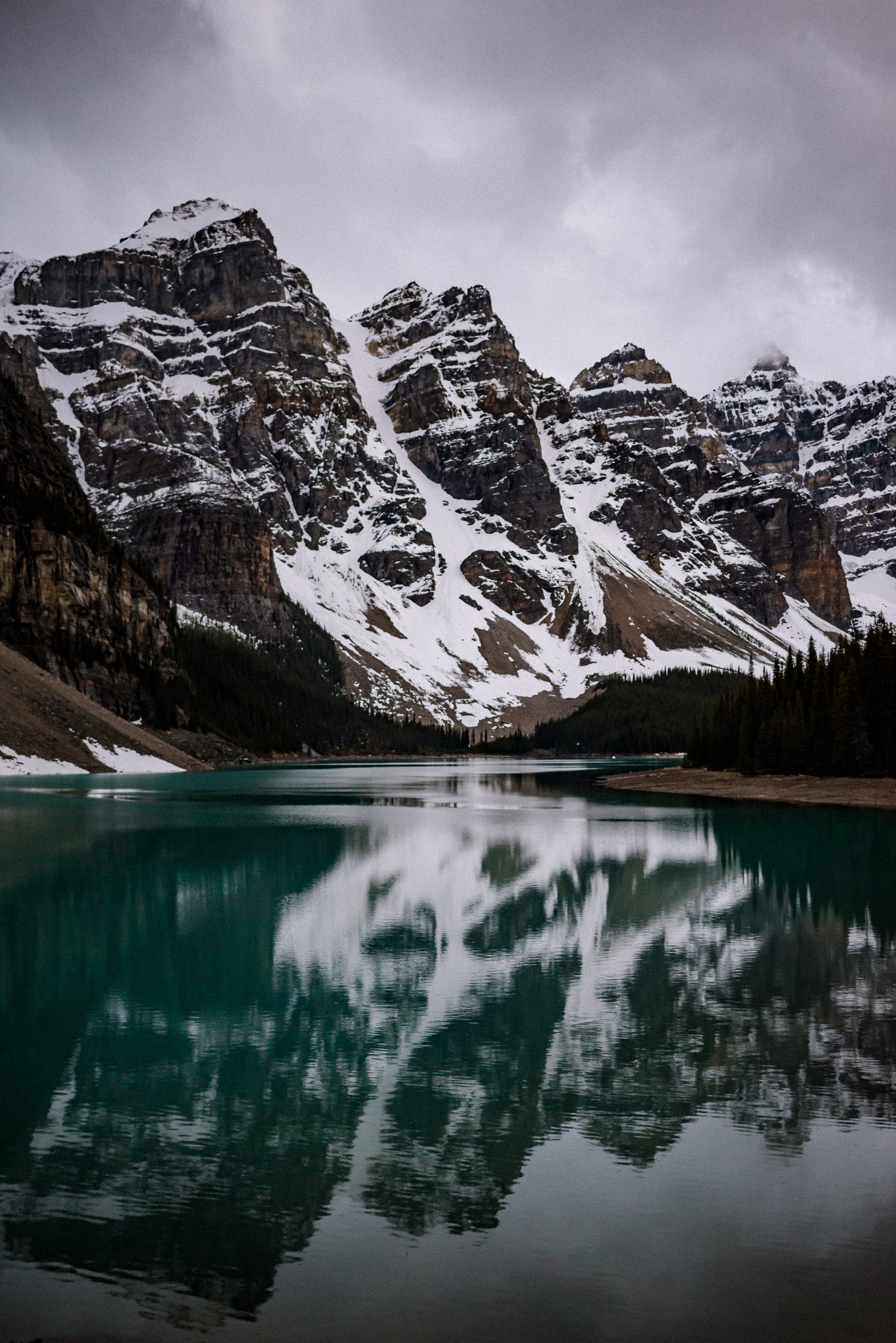 Mountains reflecting on water at Moraine Lake, Alberta